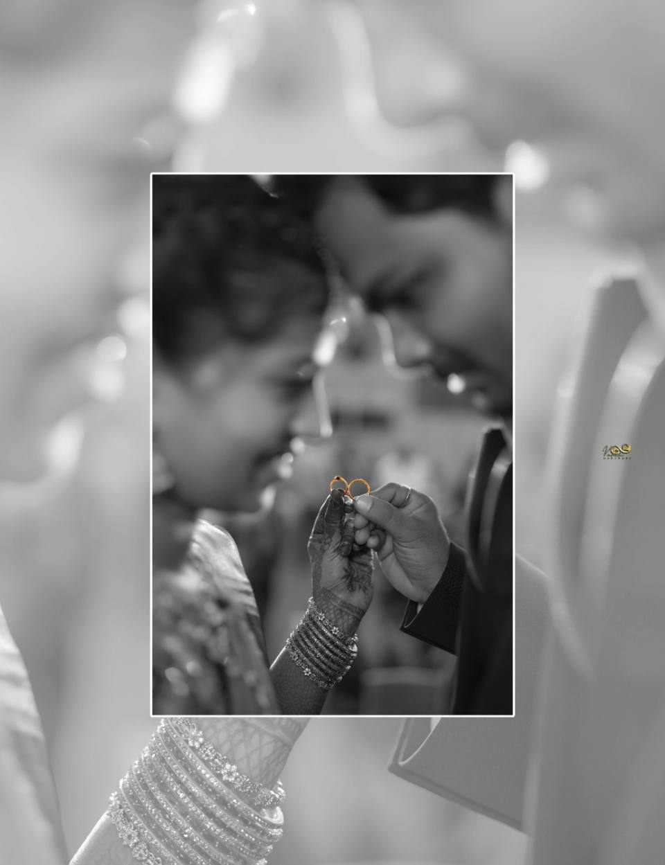 Bride and groom exchanging rings during a traditional engagement ceremony with elegant floral decorations.